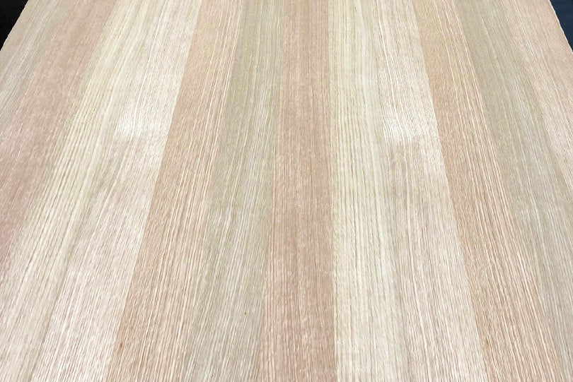 Close-up of a wooden surface with a light brown and beige striped pattern